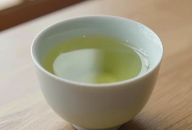 A close-up of a cup of green tea on a minimalist wooden table, soft light from a nearby window, representing the thoughtful and calm approach of Sakura.