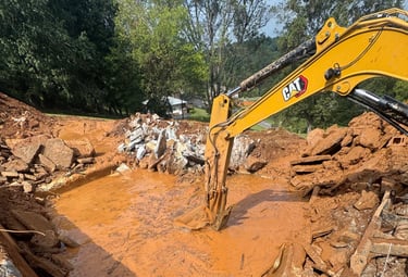 excavator digging out concrete pool
