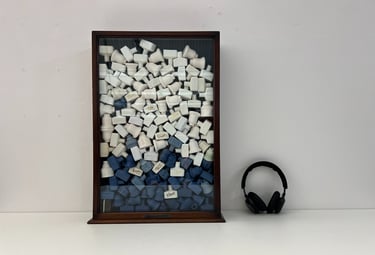 Public art installation, a cabinet filled with cast porcelain ceramic bottles and audio installation