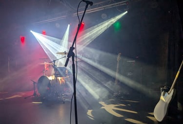 Professional stage lighting and PA setup for a Mosaic live performance at a marquee wedding