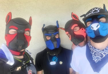 Four men. posing in pup masks.