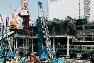 Heavy machinery and cranes working on a large scale site development and infrastructure project