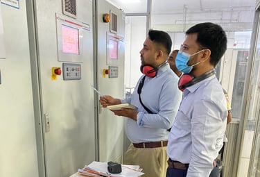 Energy auditor is checking the data of electrical power generation of a generator from the panel.