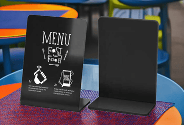 Small NFC display stand on table of a fast food restaurant, showing menu and promo content.