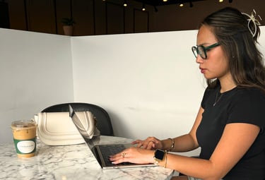 a woman sitting at a table with a laptop