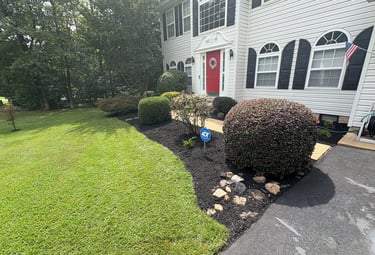 Mulch and decorative rock bed installation with custom flower bed design and edging for a Southern M