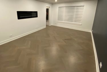 Custom herringbone hardwood flooring installation with modern fireplace in a Chicago North Shore home