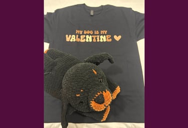 a tshirt that says "my dog is my valentine" with a stuffed rottweiler on top of it