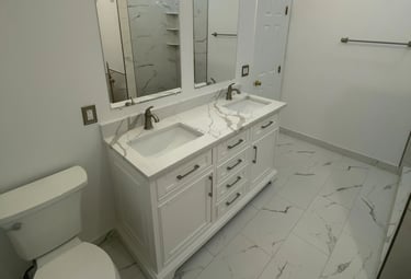 Modern bathroom with white double vanity and bronze faucets