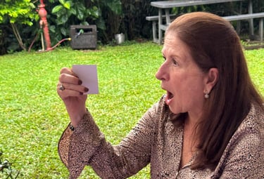 a woman holding a card and taking a selfie