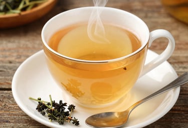 Artistic arrangement of the 23 herbs used in the brew displayed on a rustic wooden table.