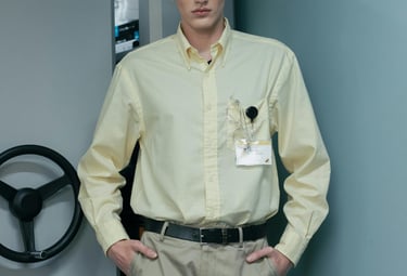 a man in a yellow shirt and khaki pants