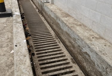 Close-up of a technician inspecting and cleaning a septic tank system.