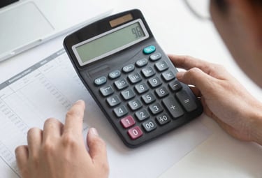 Close-up of hexagonal screws and wood screws neatly arranged on a clean white surface.