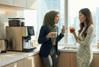 A Malay woman wearing a hijab having an argument with a Chinese long haired woman in the office pant