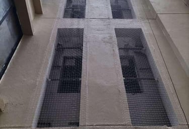 Technician carefully installing a safety net on a balcony in a residential building.