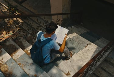 Student studying Malaysian syllabus on stairs for SPM and UASA memory mastery using PNI Neuron visual learning.