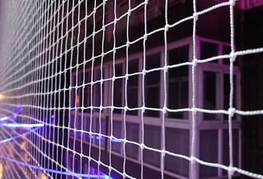 Close-up of a clean, well-maintained pigeon net stretched tightly across a balcony.