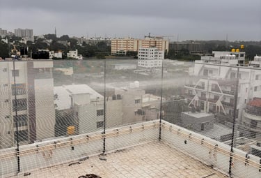 A volleyball net set up on a sunny terrace with cityscape in the background.