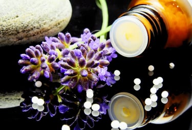 Brown glass bottle with homeopathy remedy pellets, lavender flowers, and stone for natural healing
