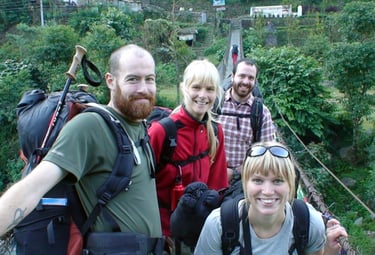 four trekkers on a bridge on the Annapurna Circuit trek.