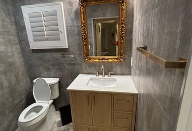 a bathroom with a toilet and a mirror