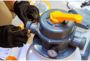A pool tech is preparing to install the pool filterer