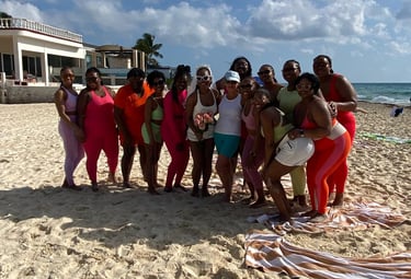 a group of people standing on a beach after Yoga on the beach Playa del carmen