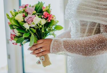 a bridesmaid holding a bouquet of flowers
