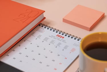 a desk with a cup of coffee and a notebook