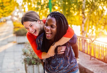 Two women laugh together