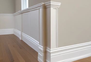 A decorative garage door with horizontal stripes in a variety of bright colors. Above the door is a sign with blue letters reading 'Humber'. The building facade is light-colored and the ground is paved.