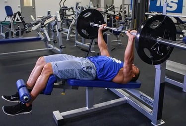 a man is doing a decline bench press in a gym