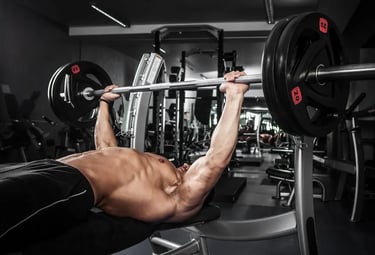 a man doing a barbell spoto press exercise on a bench