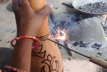 Tribal artisan engraving design on a gourd using hot iron