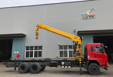 Yellow SQS300A-4 truck-mounted telescopic crane with robust boom, outdoors, ideal for heavy lifting.