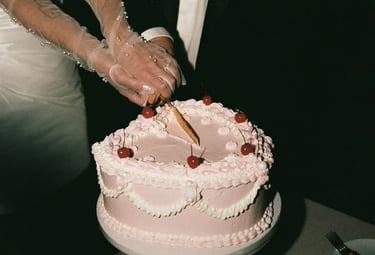 a bride and groom cutting their wedding cake