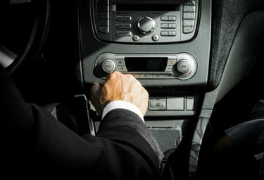 A driver is turning on a radio