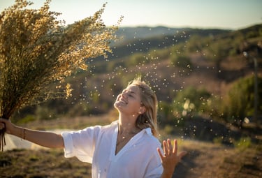 a woman holding a bunch of flowers in her hands