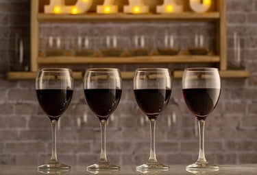 three wine glasses with wine glasses on a bar