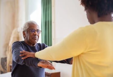 An older man and woman are joyfully dancing together, showcasing their connection and enjoyment of t