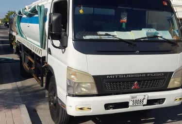 a truck with a large truck on the side of the road