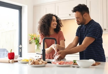 NDIS support worker assisting a participant with washing hands and preparing food together.