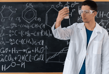 a man in a lab coat and goggles holding a cell phone