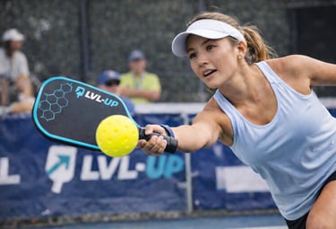 Competitive pickleball player hitting a shot during match play.