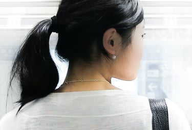 An Asian woman looks over her shoulder