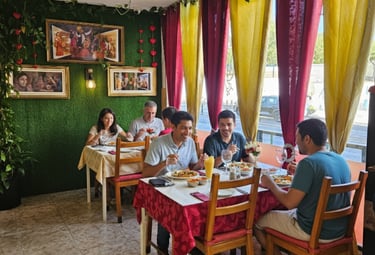 Variety of Indian cuisine including tandoori chicken, butter chicken, garlic naan, and biryani rice.