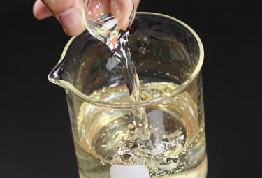 Artisan perfumer blending fragrances in a sleek, modern lab setting.