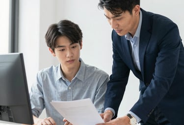 Consultant advising a student with documents in a bright office setting.