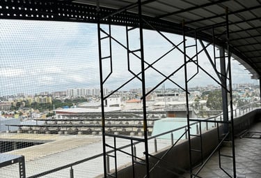 Close-up of a safety net being inspected for wear and tear on a balcony.Close-up of a safety net bei